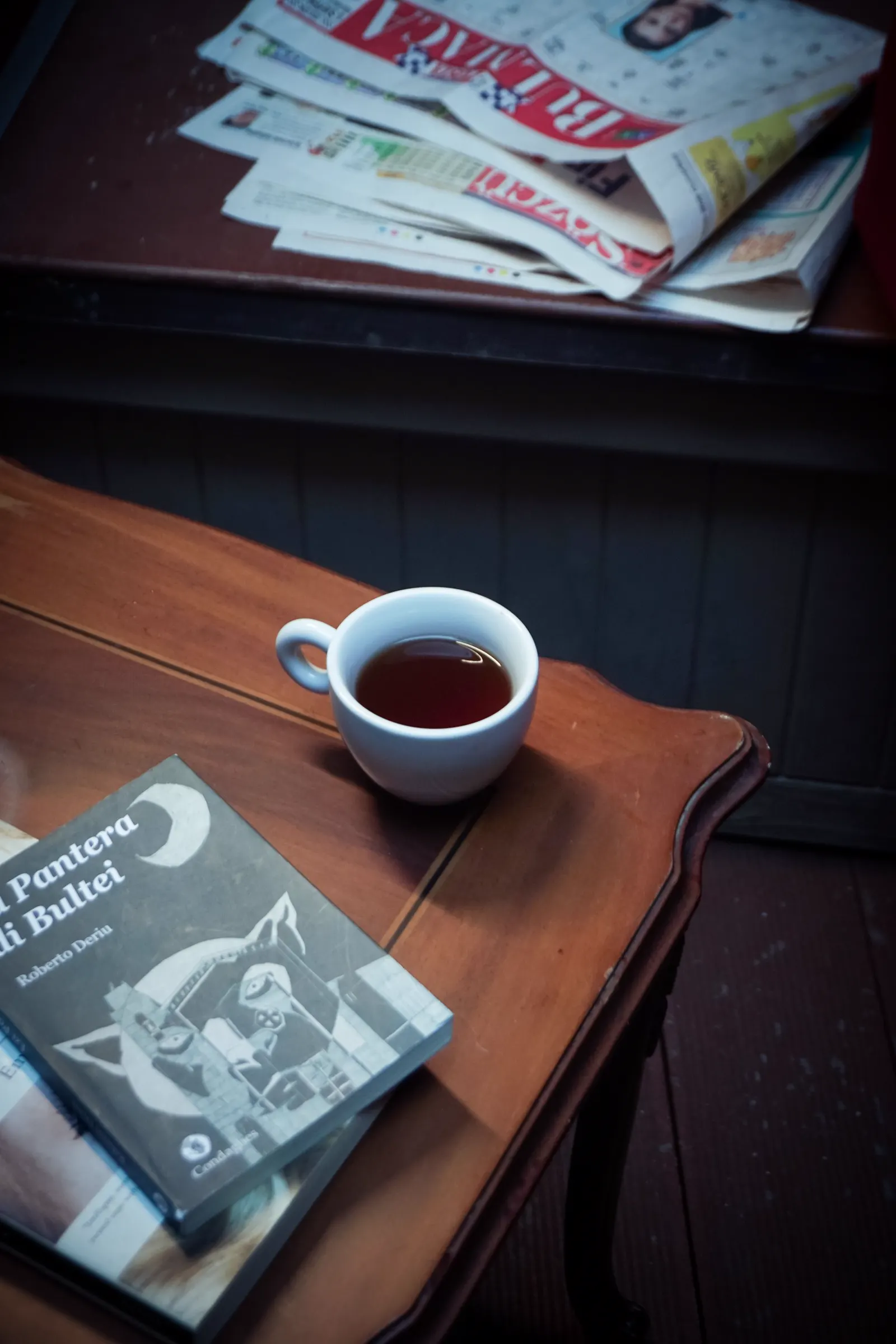 Magazines and a cup of tea in a cozy reading nook